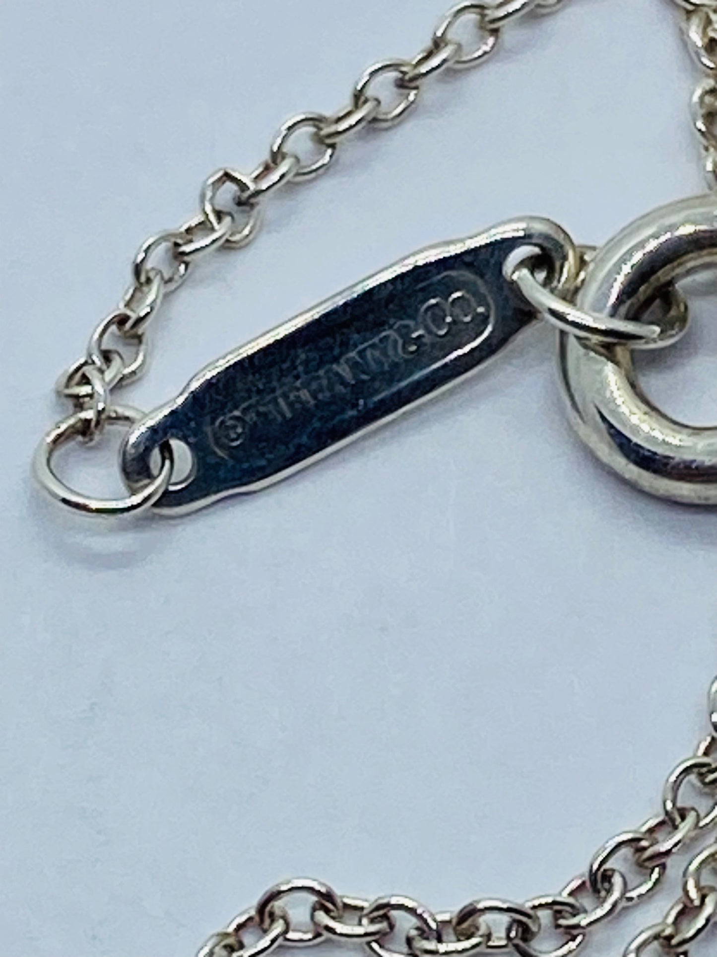 Return to Tiffany & Co. Blue Enamel Font/Writing Heart Charm Sterling Silver